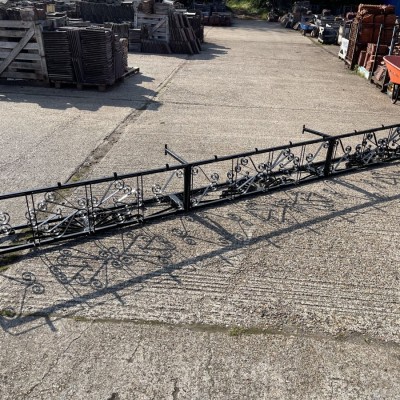 Over bar wrought iron glasses rack.