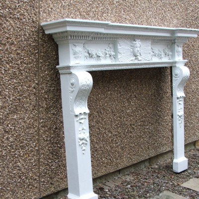 A rare George II style chimneypiece in the manner of William Kent.