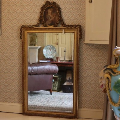 A Large gilt wood and composition wall mirror with painted panel of Marie Antoinette 